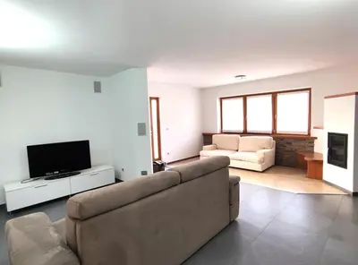 a living room with a couch and a tv at Casa Elisa apartment in Ronzone