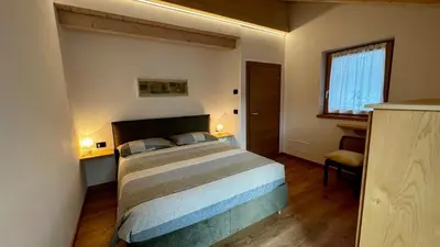 a bedroom with a large bed in a room at Pecio - Your nordic stay in Tesero