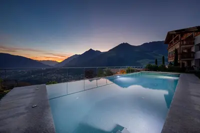 a large swimming pool with a view of mountains at Gattererhof in Schenna