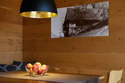 a bowl of apples on a table under a lamp at Gattererhof in Schenna