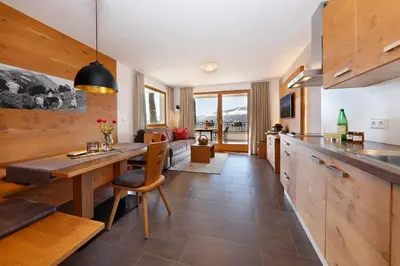 a kitchen with a table and a dining room at Gattererhof in Schenna