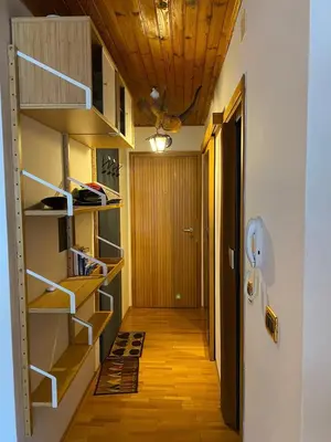 a hallway with wooden shelves and a hallway at Appartamento ai piedi delle Dolomiti in Selva di Val Gardena