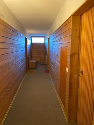 a hallway with a brick wall and a window at Appartamento ai piedi delle Dolomiti in Selva di Val Gardena