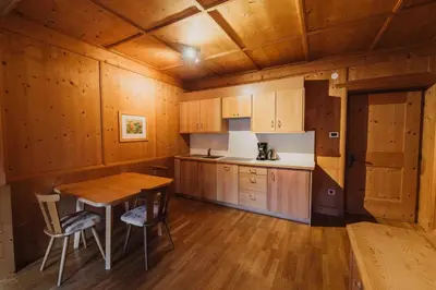 a kitchen with wooden cabinets and a wooden table at Appartements Elke in Lagundo