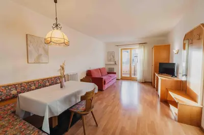 a living room with a table and a couch at Appartements Elke in Lagundo