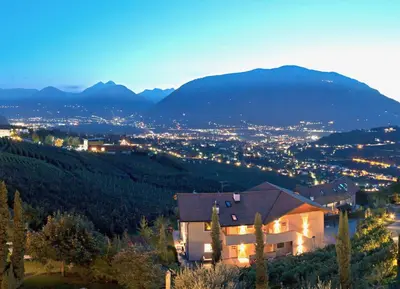 a house on a hill with a view of a city at Ferienwohnung in Schenna mit Bergblick und Pool - Unterpenatz in Schenna
