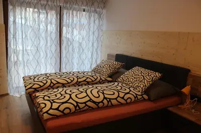 a couch with two pillows on it in a room at Apartment Claudia in Bressanone