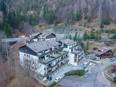 an aerial view of a large house in the mountains at Suite Monte Pelsa in Alleghe