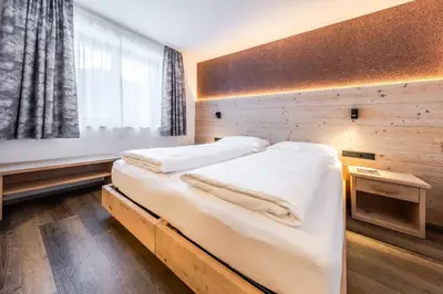 a bedroom with two beds and a window at CHALET ARIA Stay Mountain Relax in Arabba