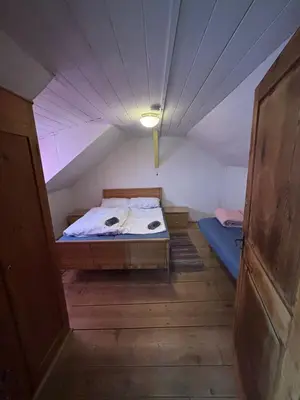 a small room with a bed in a attic at Hühnerspielhütte - Rifugio Gallina - Mountain Hut Hühnerspielhütte in Moncucco
