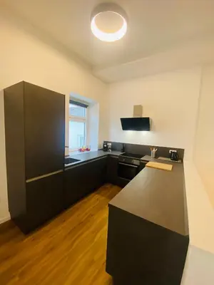 a black and white kitchen with a counter top at Amort Suites Meran in Merano