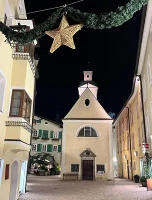 a building with two stars hanging over a street at Vista Dolomiti in Bressanone