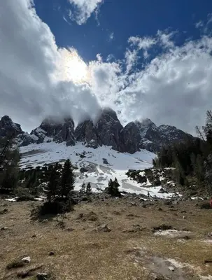 a snow covered mountain with clouds in the sky at Vista Dolomiti in Bressanone