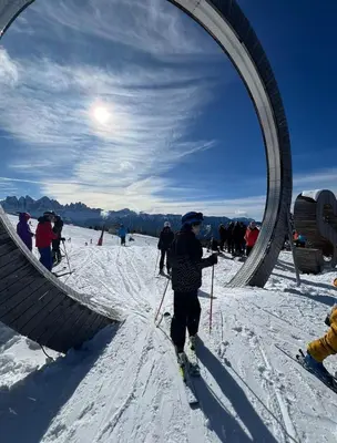 a person on skis in the snow under a arch at Vista Dolomiti in Bressanone