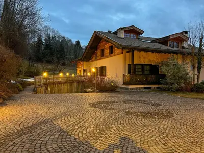a house with a brick driveway in front of a house at B&B Profumi nel bosco in Carano
