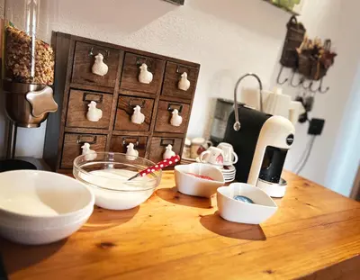 a counter with bowls and a mixer on a table at B&B Profumi nel bosco in Carano