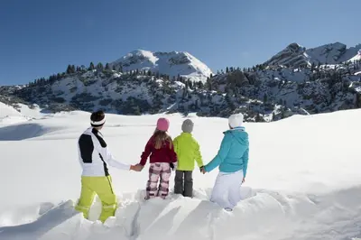 a group of people standing in the snow at Pension Aichner in Terento