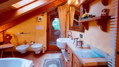 a bathroom with two sinks and a toilet in a cabin at Elegante Attico a San Vito in San Vito di Cadore