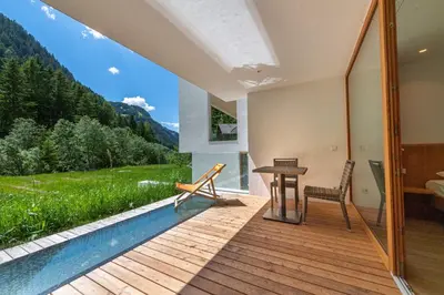 a house with a pool and a view of the mountains at Apartments Greva 2 in Santa Cristina in Val Gardena