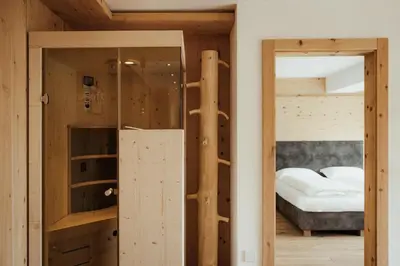 a kitchen with wooden walls and a counter top at Ciasa Linde in Longega