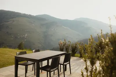 a table and chairs with a view of a mountain at Ciasa Linde in Longega