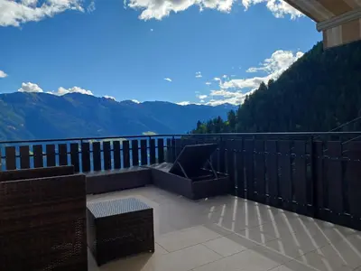 a balcony with a laptop on it with a view of mountains at Rabensteinhof - Urlaub auf dem Bauernhof in Parcines