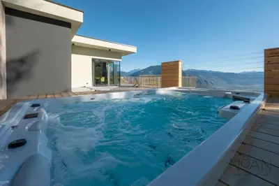 a hot tub on top of a house at NoAN Panorama Suiten - D i c k e n s in San Genesio Atesino