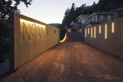 an empty road with a wall with the words nova on it at NoAN Panorama Suiten - D i c k e n s in San Genesio Atesino