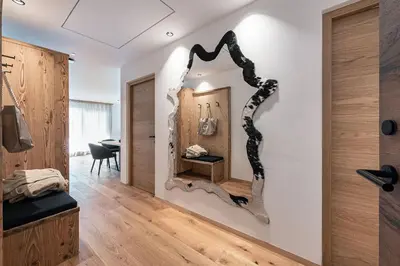 a room with a mirror on the wall at Krahof Dolomites - Urlaub auf dem Bauernhof in Castelrotto
