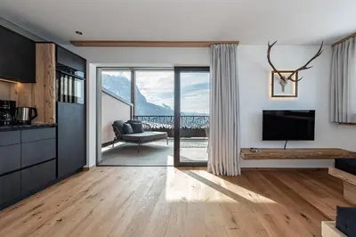 a living room with a television and a couch at Krahof Dolomites - Urlaub auf dem Bauernhof in Castelrotto