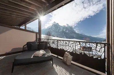a balcony with a bed and a view of a mountain at Krahof Dolomites - Urlaub auf dem Bauernhof in Castelrotto