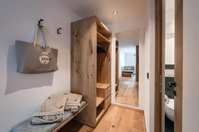 a room with a closet and a bag on the wall at Krahof Dolomites - Urlaub auf dem Bauernhof in Castelrotto