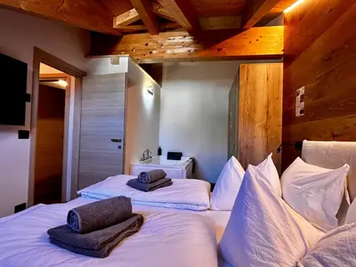 a bedroom with two beds with pillows on them at Casa Franz in Tesero