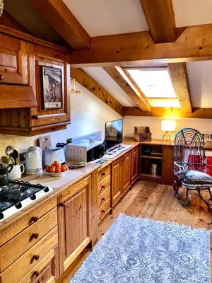 a bathroom with a sink and a washing machine at Mansardina Mery Cortina - Studio - in Cortina dʼAmpezzo