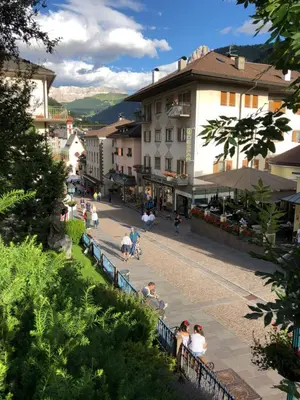 a group of people walking down a street at Appartements Tlusel in Ortisei