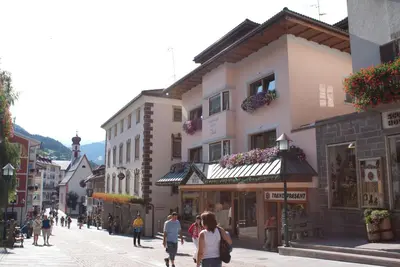 a group of people walking down a street at Appartements Tlusel in Ortisei