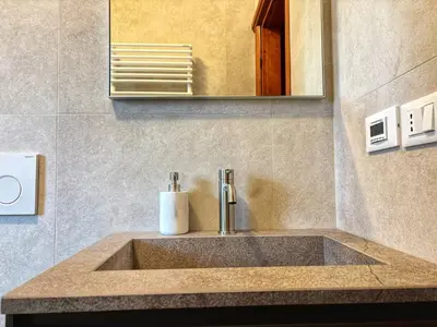 a sink in a bathroom with a mirror at Large Central Flat, 5min to Sky Slopes, Garage in Cortina dʼAmpezzo