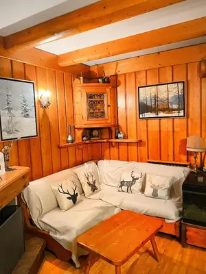 a living room with a white couch and a table at Large Central Flat, 5min to Sky Slopes, Garage in Cortina dʼAmpezzo