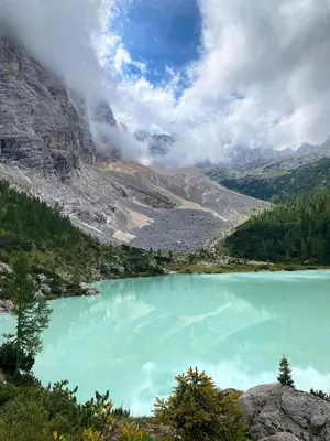a view of a blue lake in the mountains at Large Central Flat, 5min to Sky Slopes, Garage in Cortina dʼAmpezzo