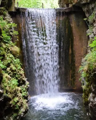 a waterfall in the middle of a river at SISSI MENDEL Residence in Ronzone