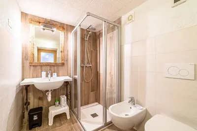 a bathroom with a sink and a toilet and a shower at Appartamento Vecchia Osteria in Rocca Pietore
