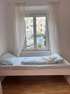 a bed in a room with a window at Druso Rooms in Bolzano