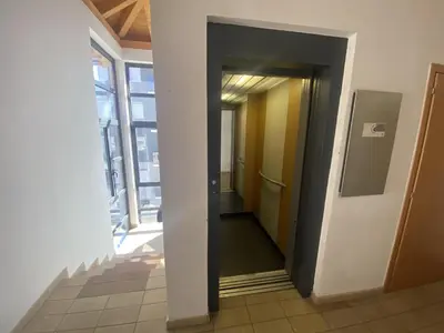 a hallway of an office with an open door at Casa LaLu in Cavalese