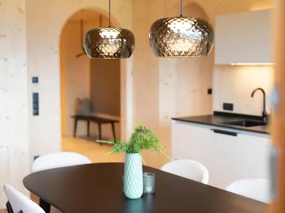 a kitchen with a table with a vase on it at Mair am Graben Farm Chalets in Terento