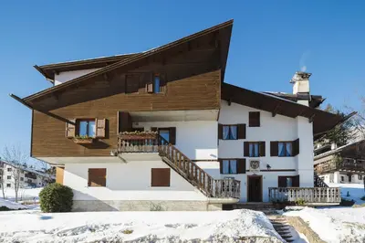 a house in the winter with snow on the ground at Villa Casanova - Stayincortina in Cortina dʼAmpezzo