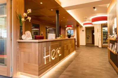 a lobby of a store with a reception counter at Hotel Garni Herz in Tirolo