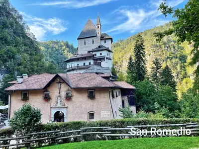 a building with a castle on top of it at Agritur Casa al Mulino Camere in Sanzeno