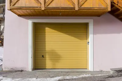 a balcony on the side of a building with a yellow door at Dolomites with Love in Mazzin
