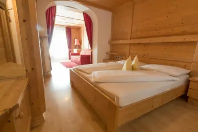 a bedroom with a large bed in a room at Pension Garden Hotel in Colfosco