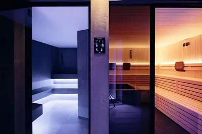 a bathroom with a glass door in a room at Hotel Else in Selva di Val Gardena